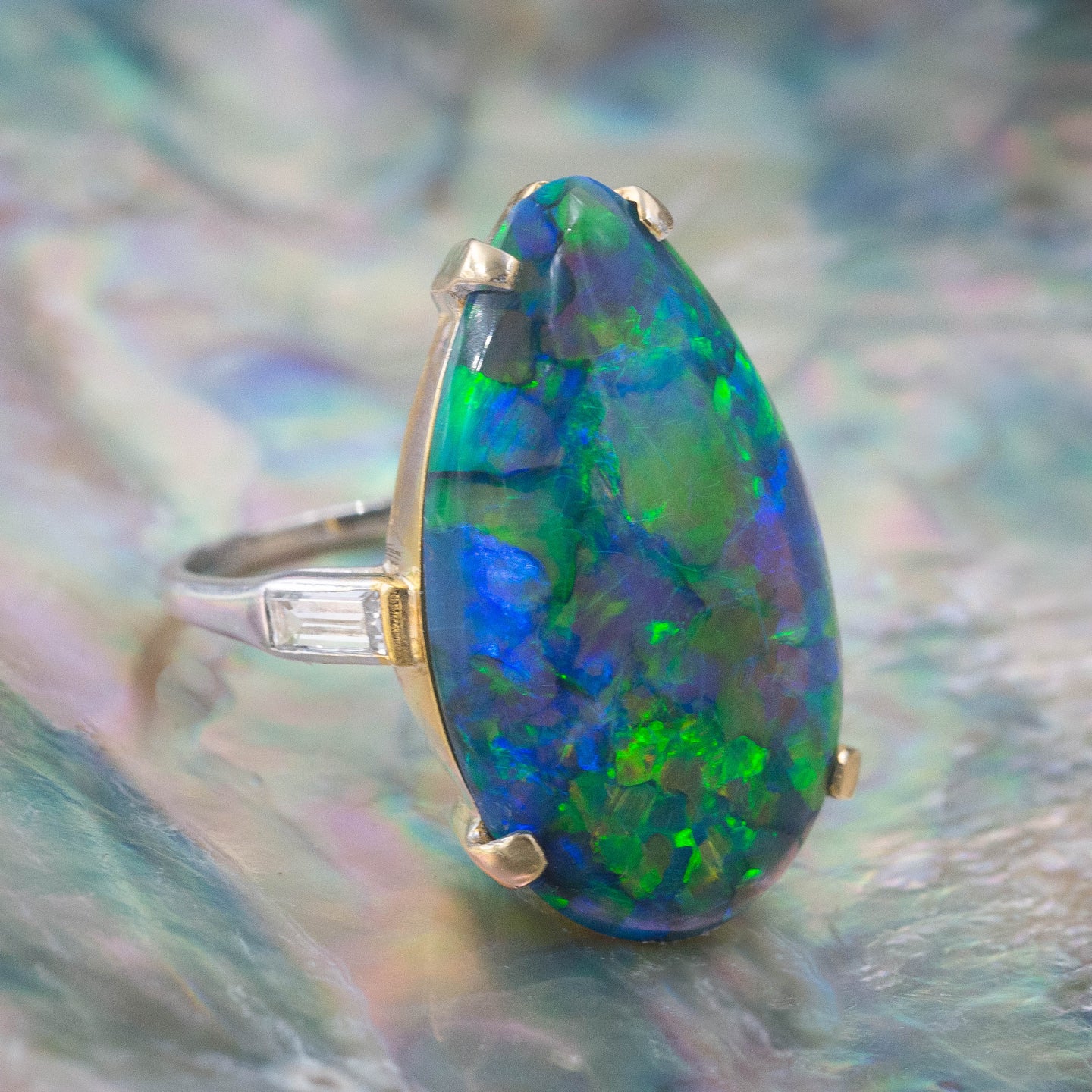 Premium Photo | A gold ring with a black opal stone on it