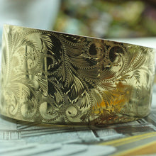 Exquisitely hand chased 1960s 14k gold hinged bangle