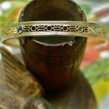 Elegantly pierced Edwardian 14k oval bangle with diamond and sapphires